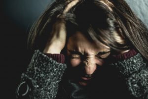 woman-holding-her-head-2128817-300x200.jpg