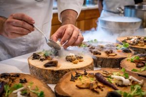chef-preparing-vegetable-dish-on-tree-slab-1267320-300x200.jpg